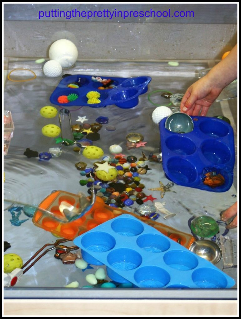 Space themed water table with sun, moon, star and planet shapes to use with scoops and sorting trays.