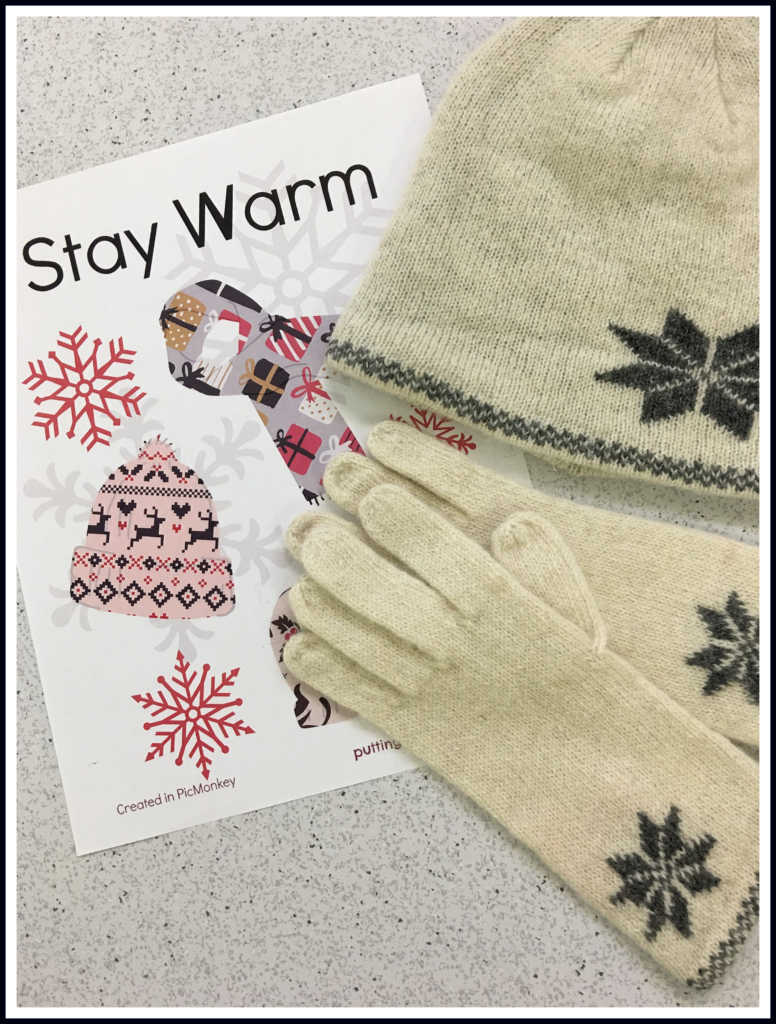 Stay warm station with sign and winter accessories.