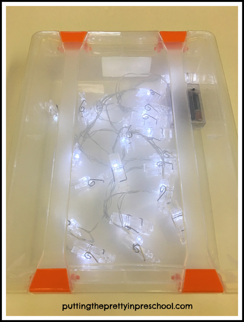 A lid covered clear plastic tub with led lights inside works as a small light table.