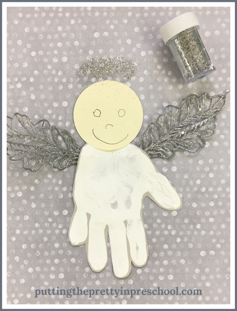 Invitation to add a silver glitter halo to a handprint angel.