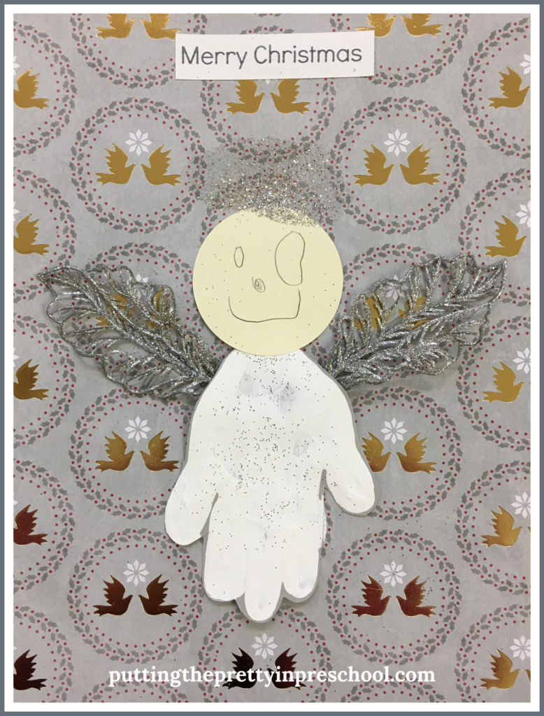 Handprint angel craft with the caption "Merry Christmas." An easy to make keepsake all children can create.