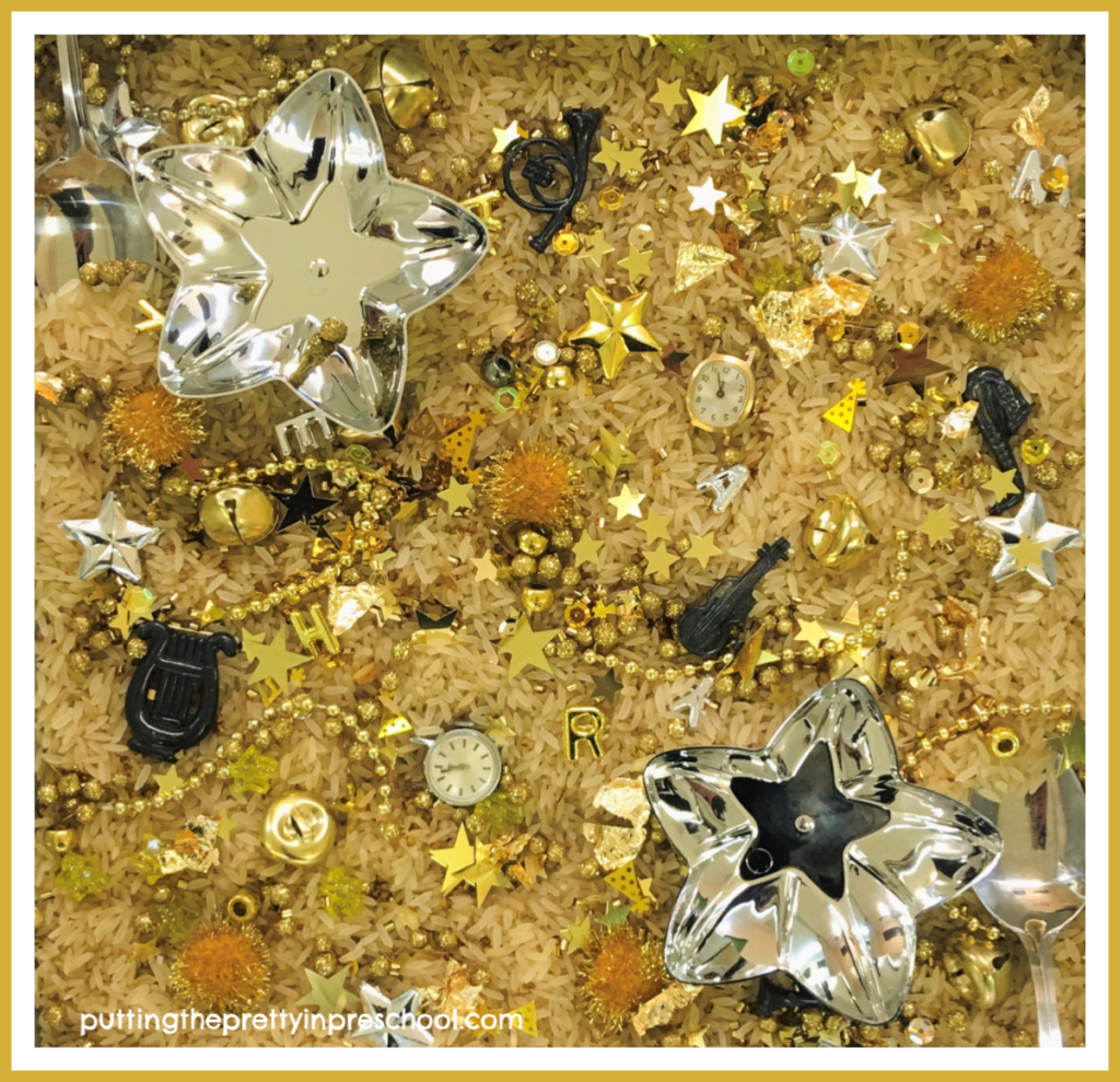 New Year's sensory tray with gold and silver pieces. Two antique watch heads are the highlights. This tray offers math, language and sensory opportunities for learning.