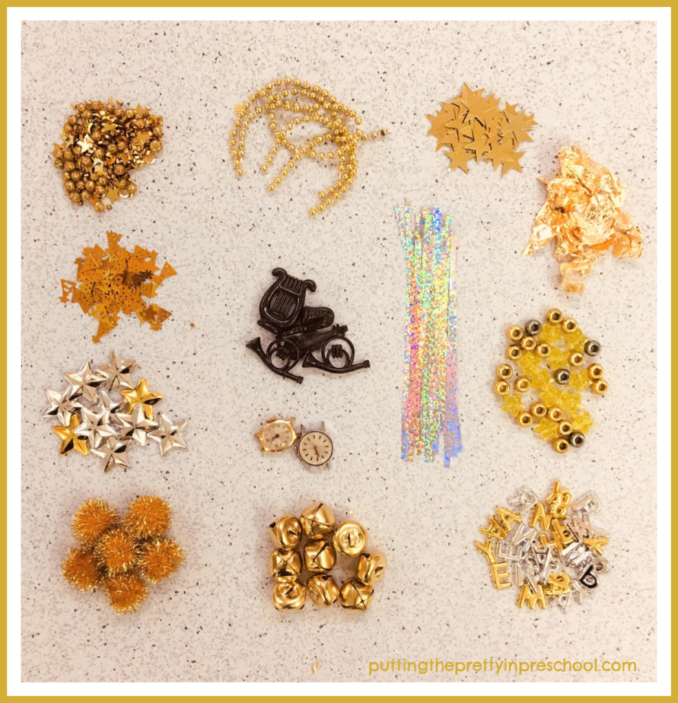 Gold and silver supplies to use in a New Year's sensory tray. Opportunity to sort and count pieces and make sets. Invitation to spell the wish "Happy New Year."