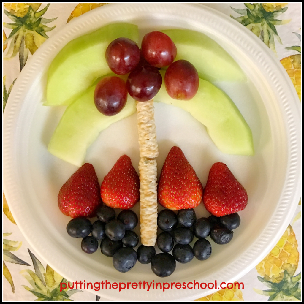 Palm tree scene made with fruit and coconut rolls for a Hawaiian party snack.
