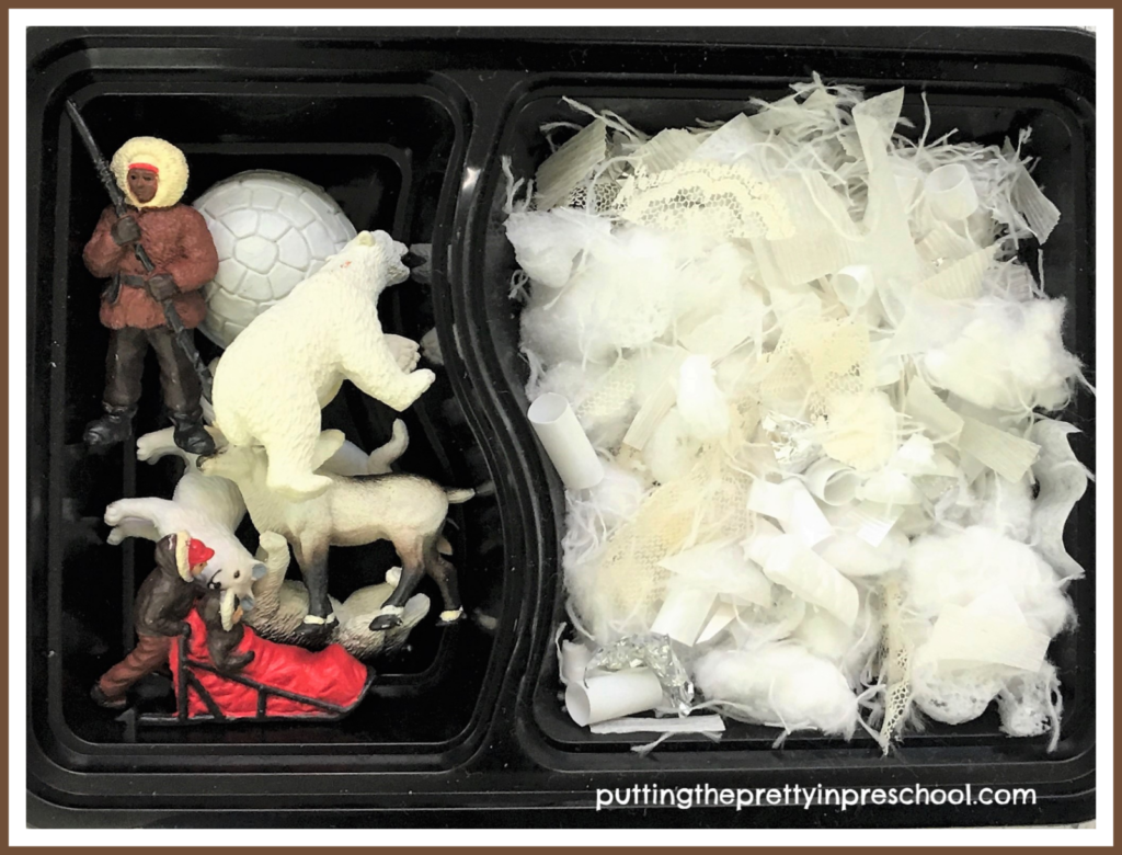 A snack tray repurposed as a small world with snipped craft supply snow and polar figurines. With a lid snapped on this play tray is transportable.
