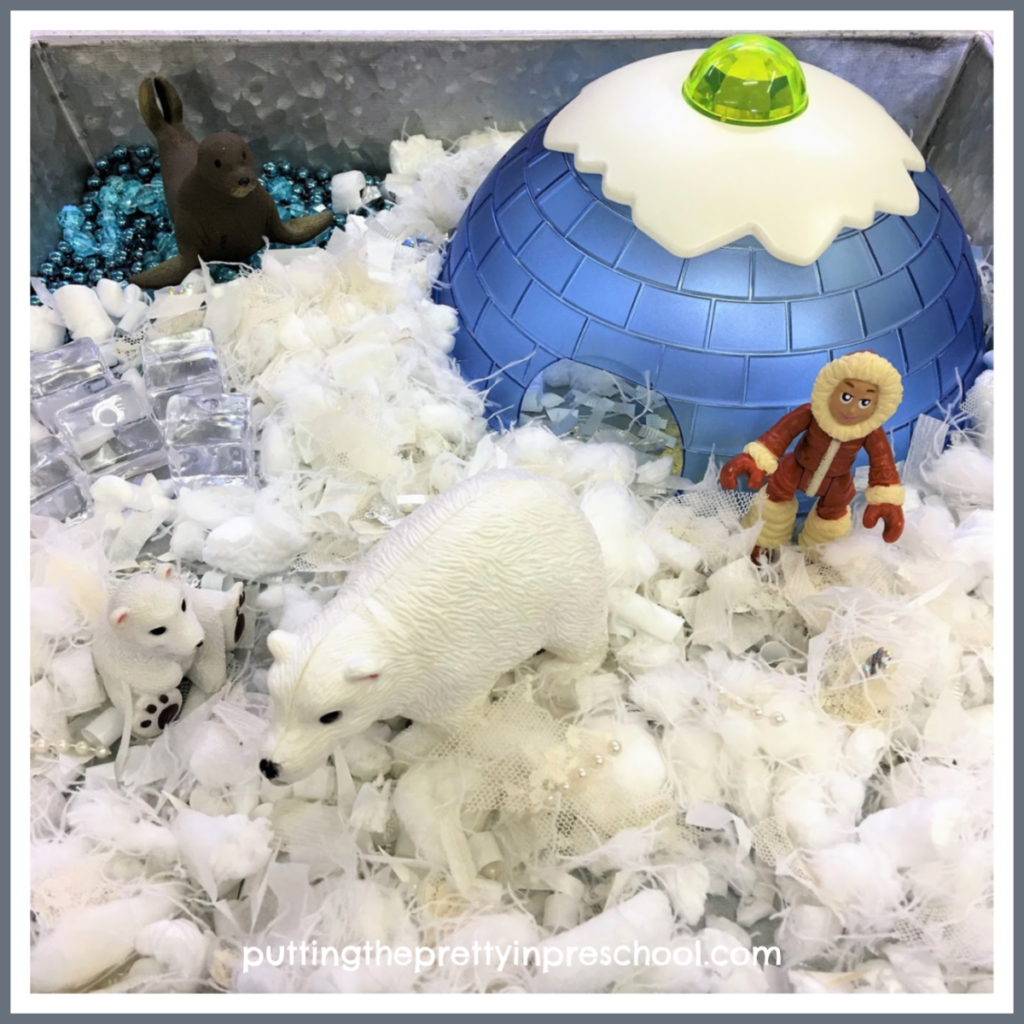 Polar small world with craft supply snipped snow, gem ice cubes, and bead garland water.