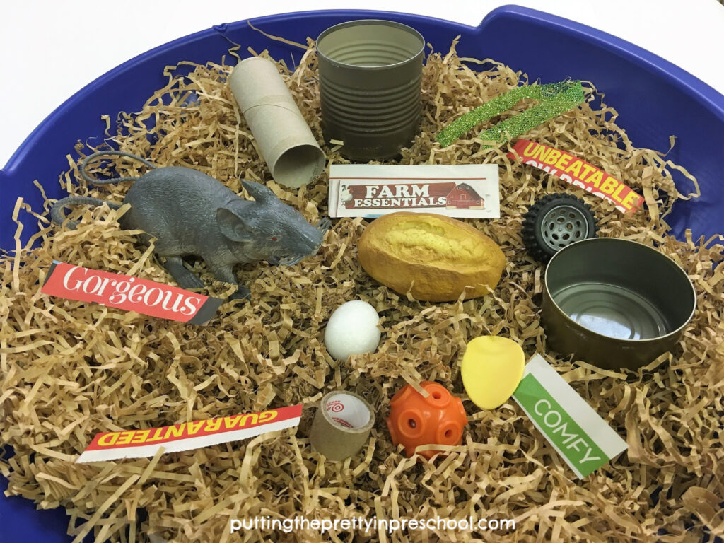 Templeton the rat's treasure finds sensory tub. Toys, play food, loose parts, descriptive words, and a rat figurine are added to the bin.