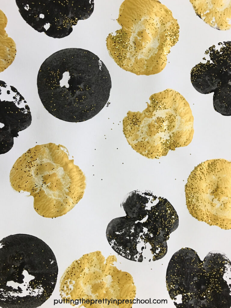 Black and metallic gold apple prints with gold glitter for the finishing touch.