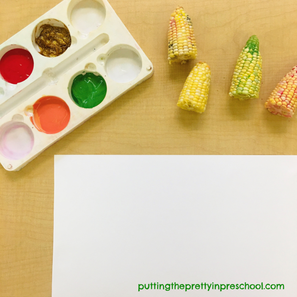 Invitation to make paint prints with sliced corn cobs.