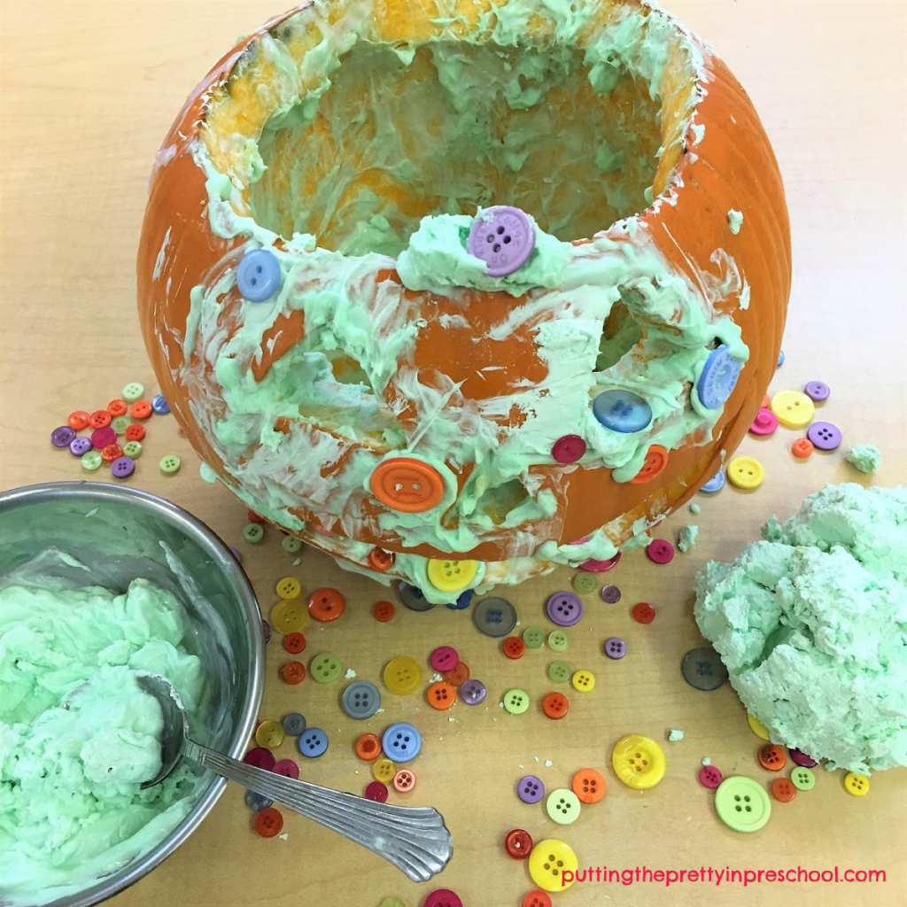 Invitation to explore scented conditioner slime and use it with buttons to decorate a pumpkin.
