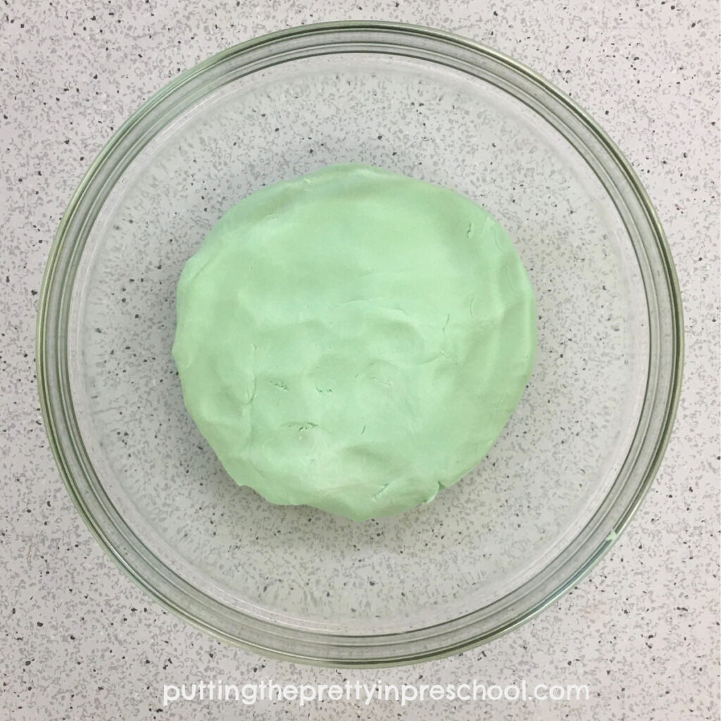 Green apple playdough batch using two ingredients and optional food coloring. A dreamy, soft playdough that responds well to human touch.