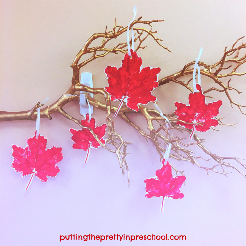 Leaf display on a twig made with maple leaf paint prints.