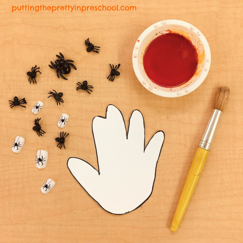 Supplies needed to create an orange, spider-themed hand.