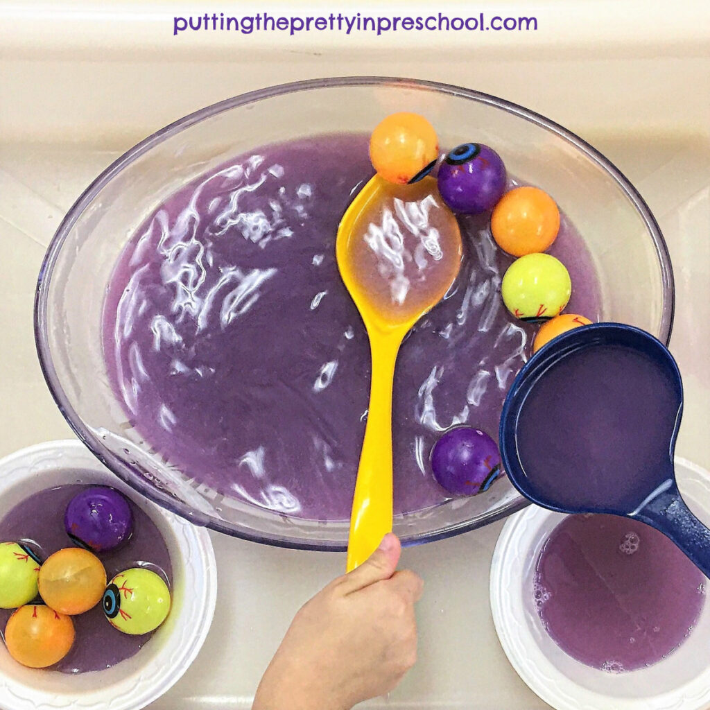 Milky purple water and plastic eyeball "soup" play station.