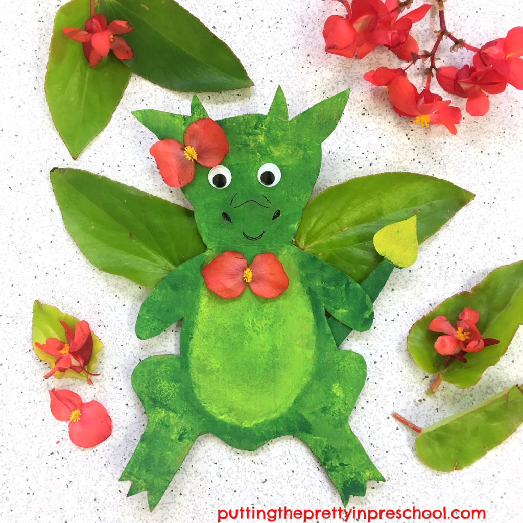 Cardboard dragon with dragon wing begonia wings and flower accents.