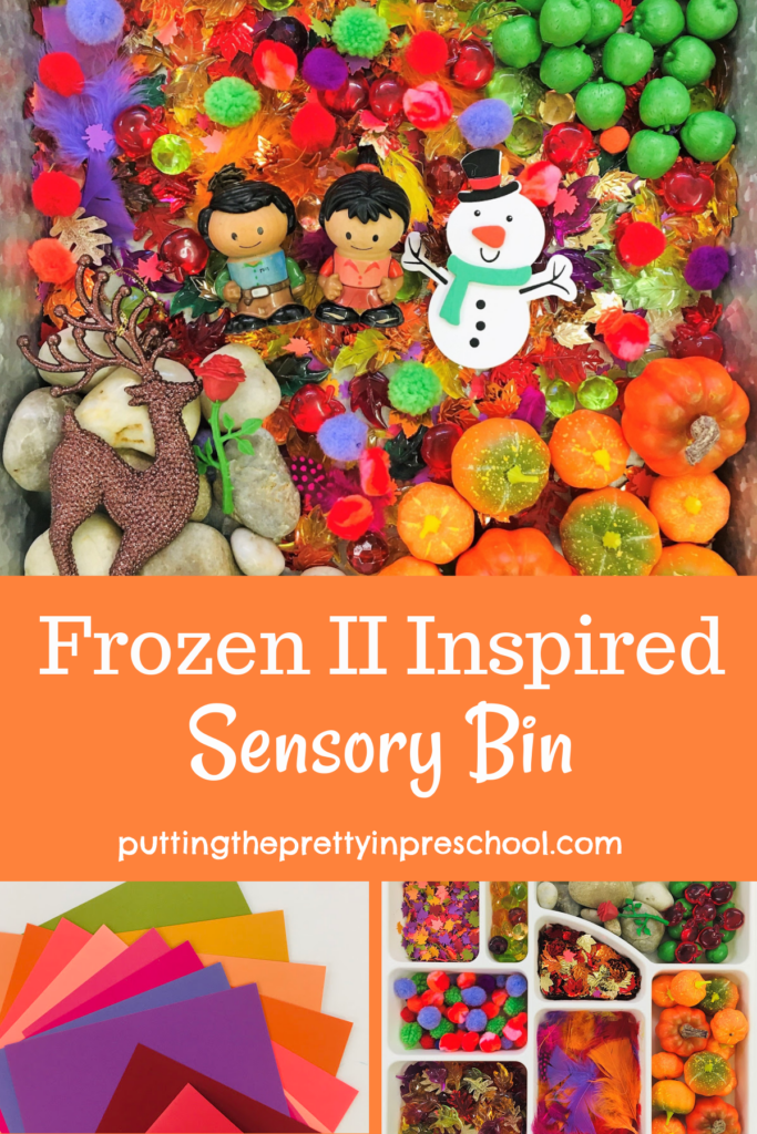 Frozen 2 inspired sensory bin with pumpkins, apples, leaves, rocks, and craft supplies. A reindeer, snowman, and people characters complete the bin.