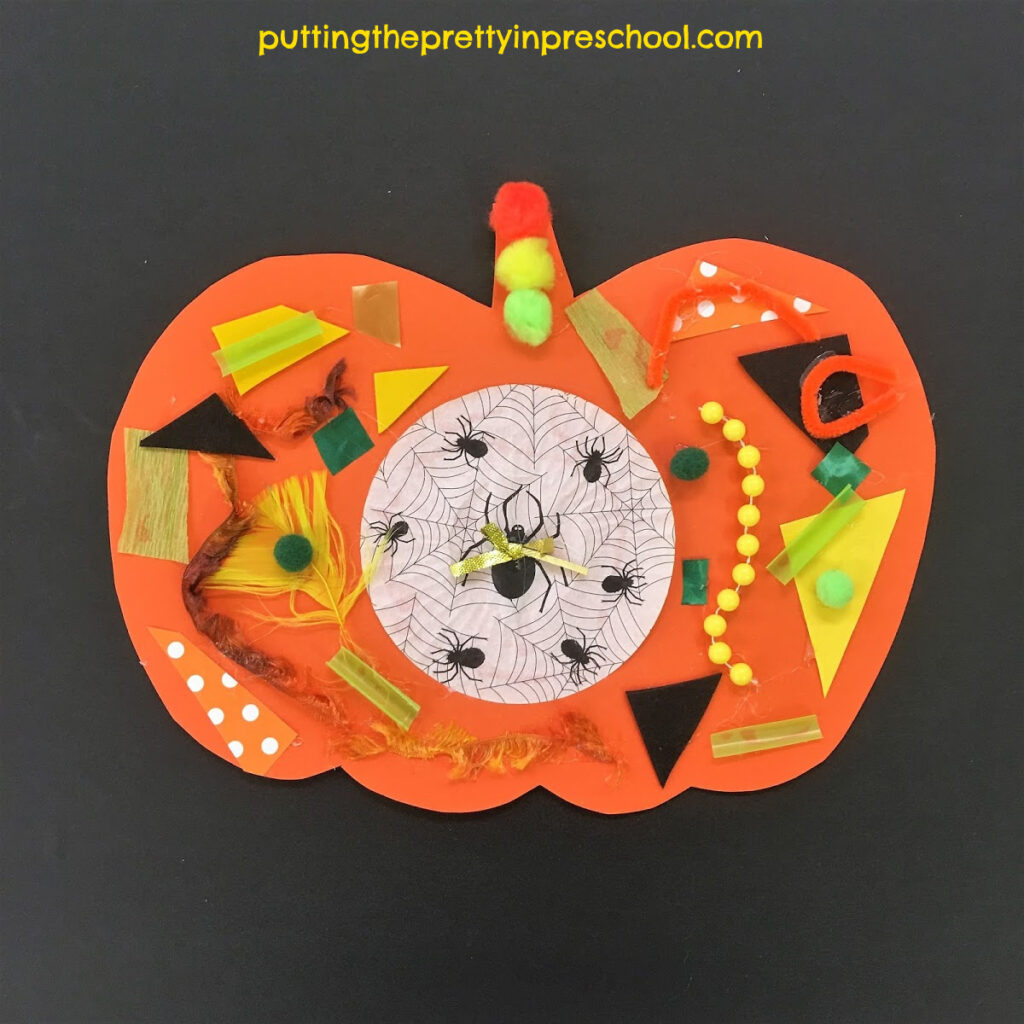 Pumpkin collage craft with textured green, yellow, orange, and black supplies.