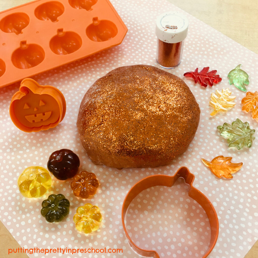 Pumpkin playdough with pumpkin-themed loose parts.