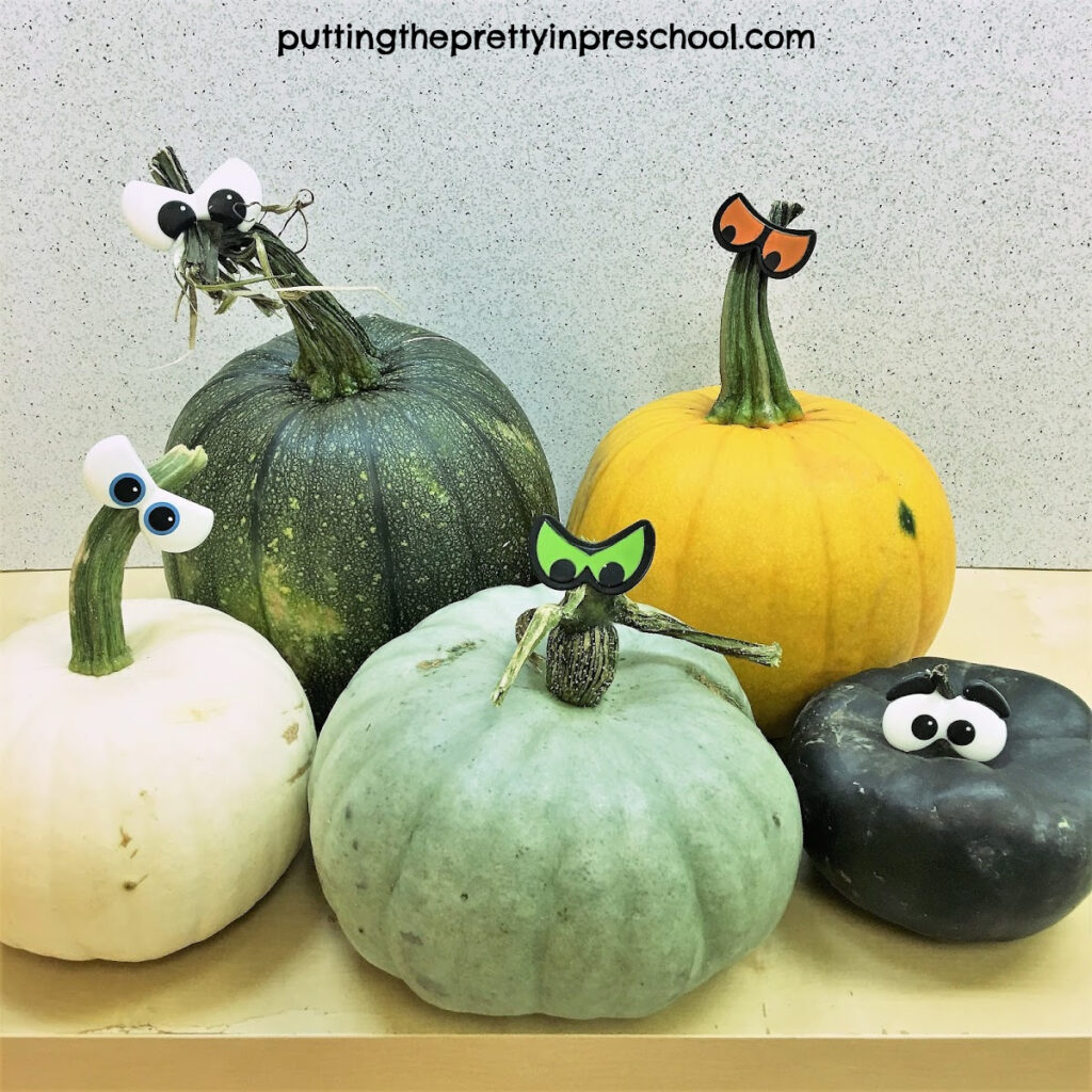 Pumpkins in mint, cream, black, yellow, and green colors.