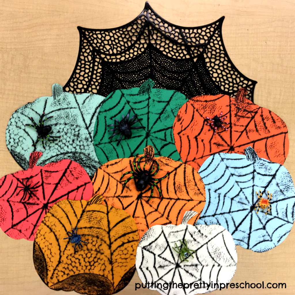Crayon rubbings of spider webs on colored pumpkins. An all-ages art activity.