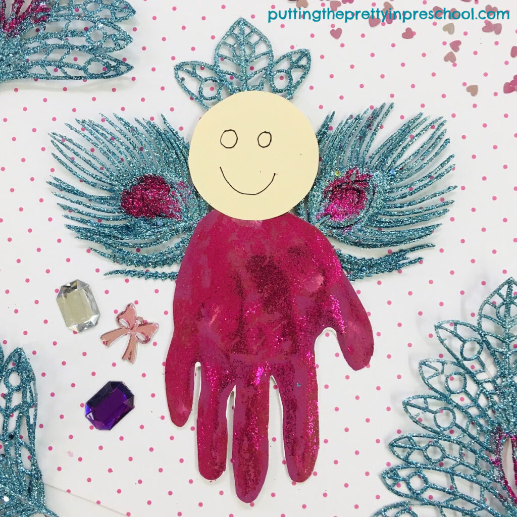 Turquoise and magenta handprint Christmas angel craft.