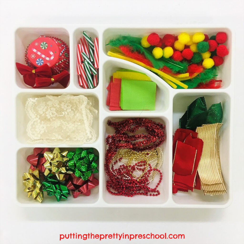 Compartment sorting tray with Christmas-themed craft supplies.