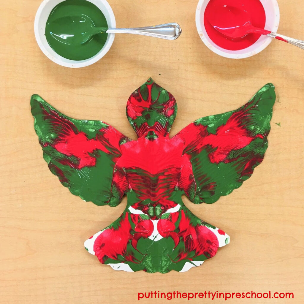 Squish painted dove art project in red and green colors.