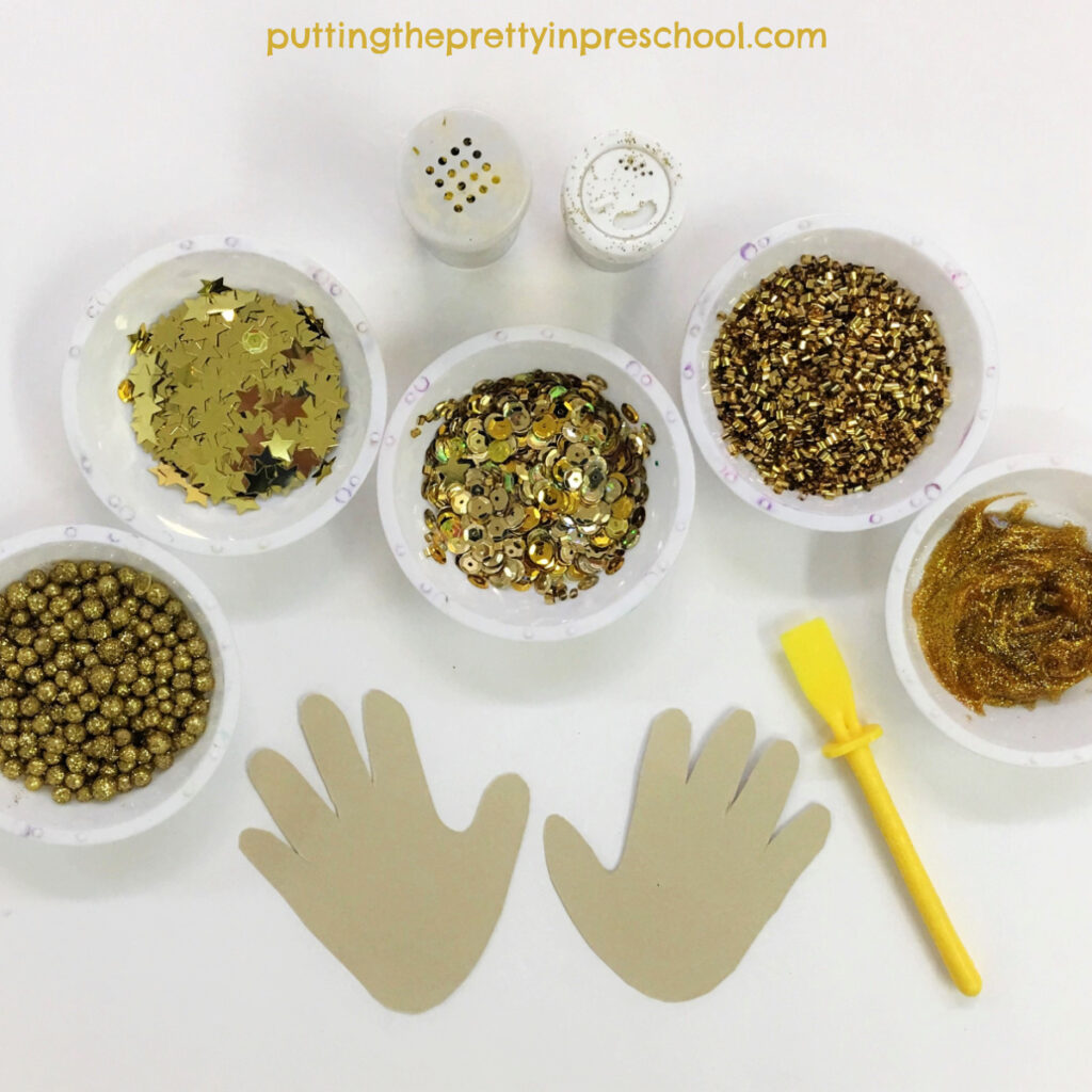 Gold craft supplies to decorate traced hands.