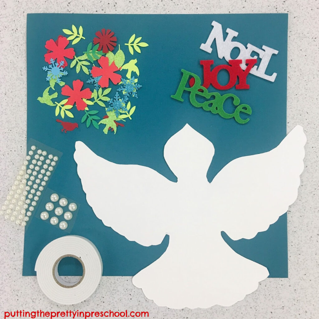 Supplies needed to make a papercraft dove Christmas keepsake.