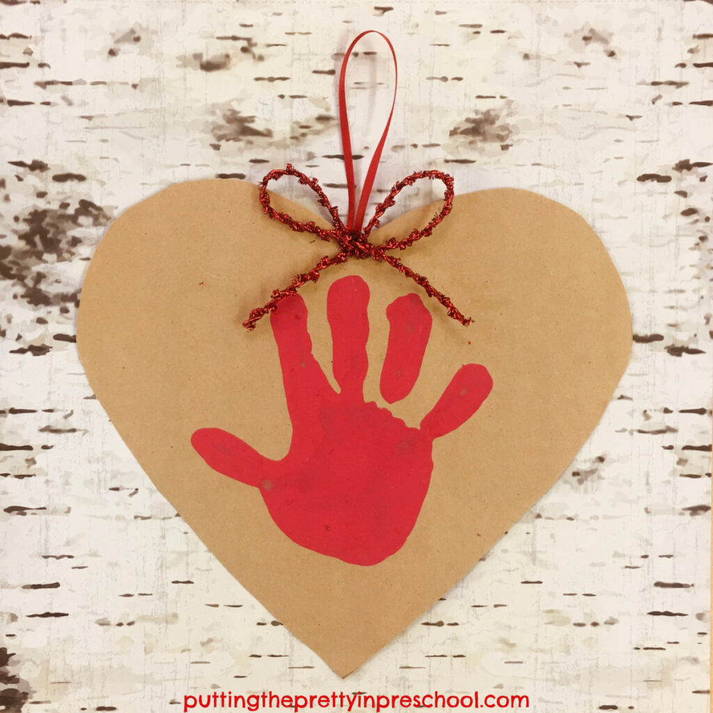 Red handprint heart craft ready for hanging.