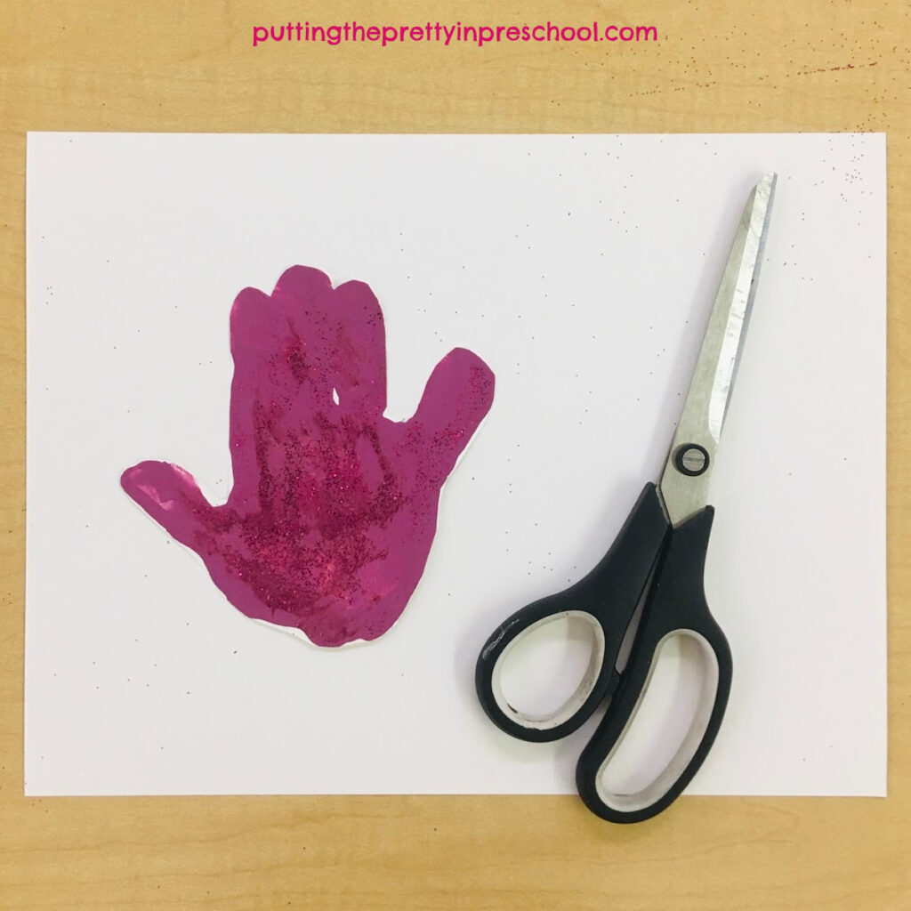 Scissors to cut a painted handprint for an angel craft.