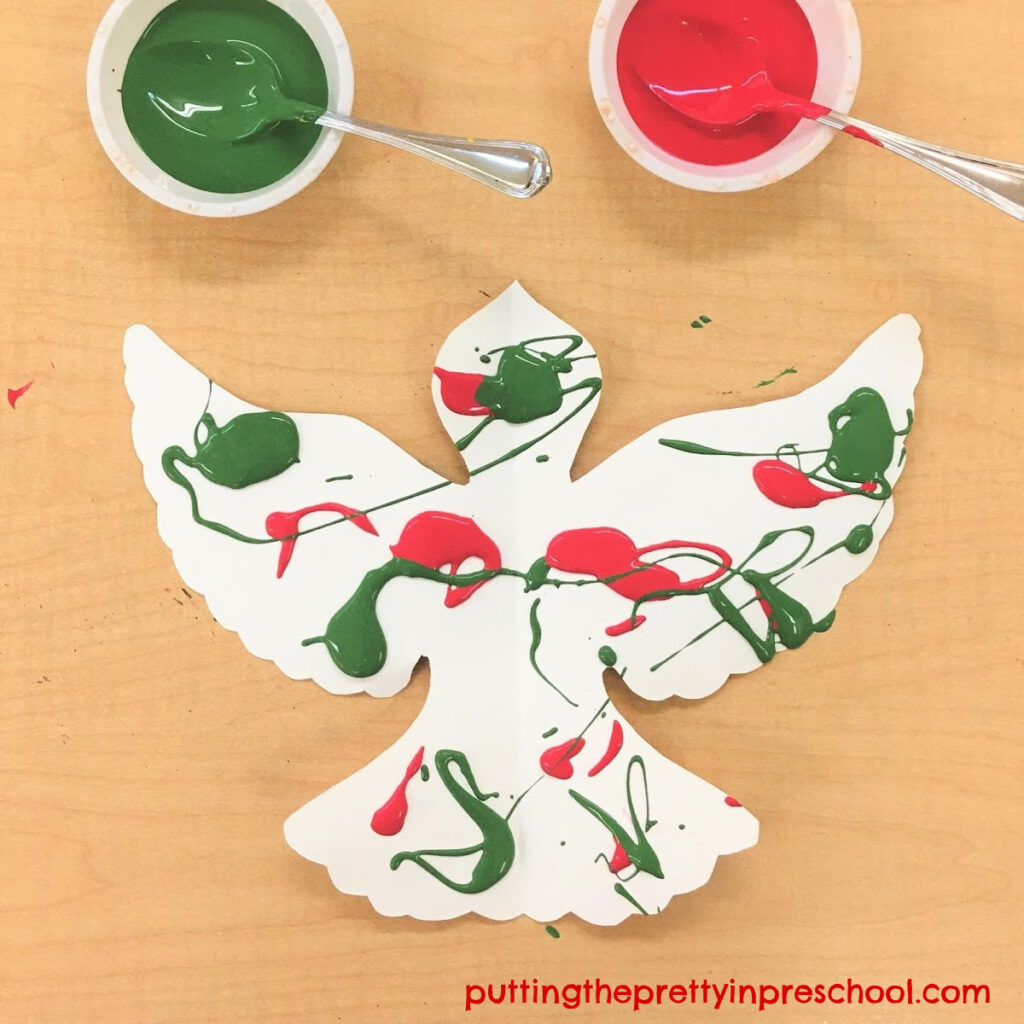 Spatter painted dove using green and red Christmas colors.