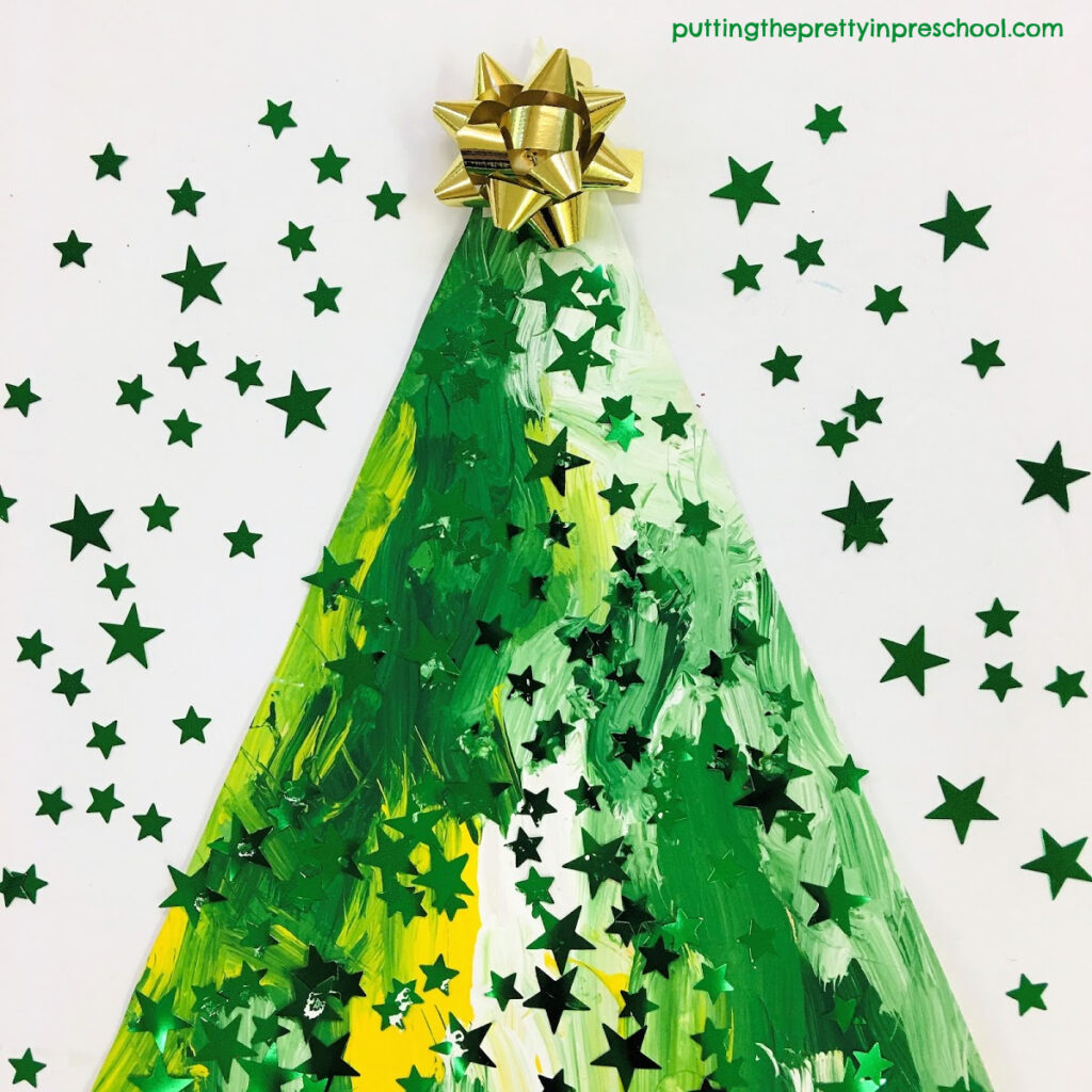 A Christmas gift bow is the topper for this painted Christmas tree craft.