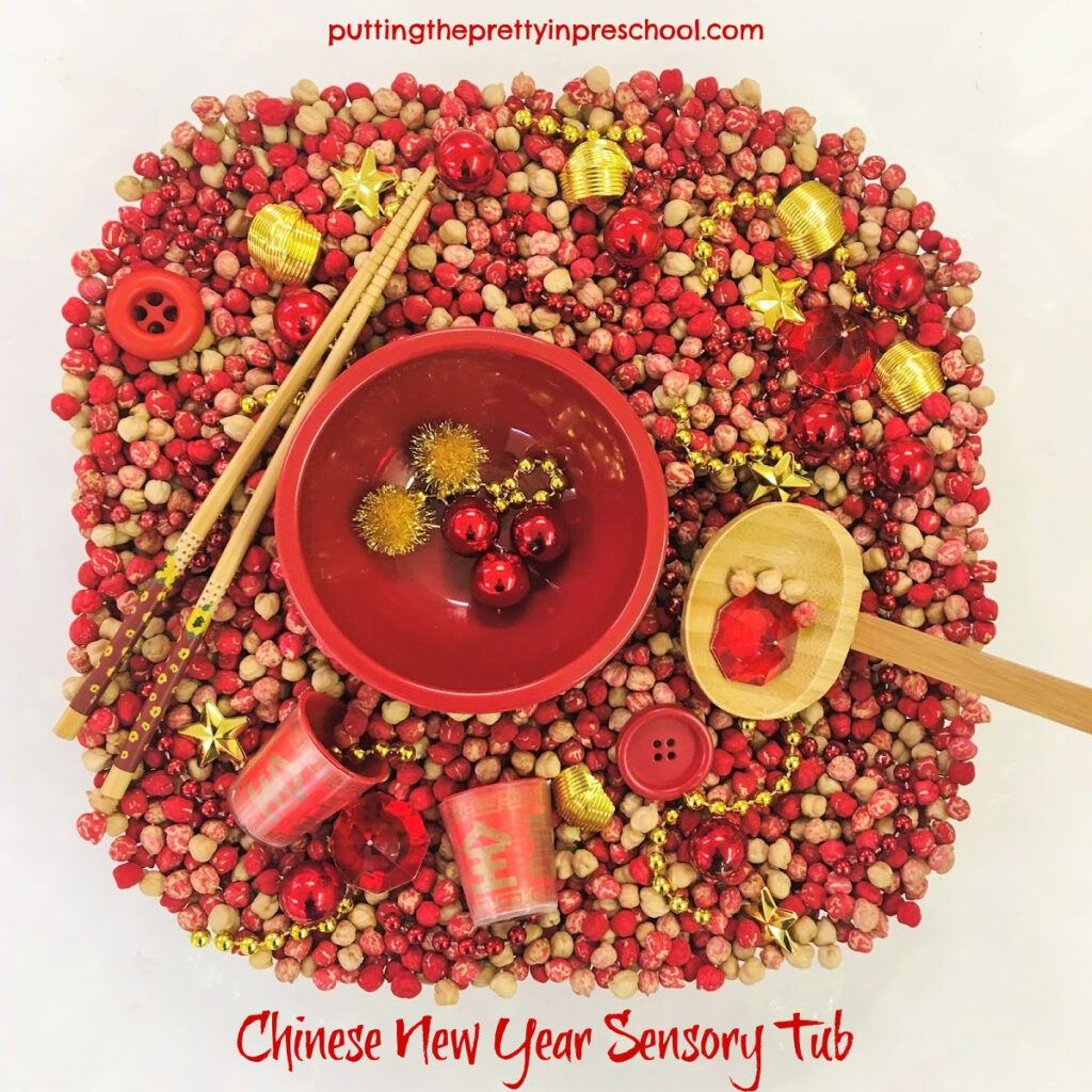 Dyed chickpeas in a tulip-shaped punch bowl with red and gold accessories.