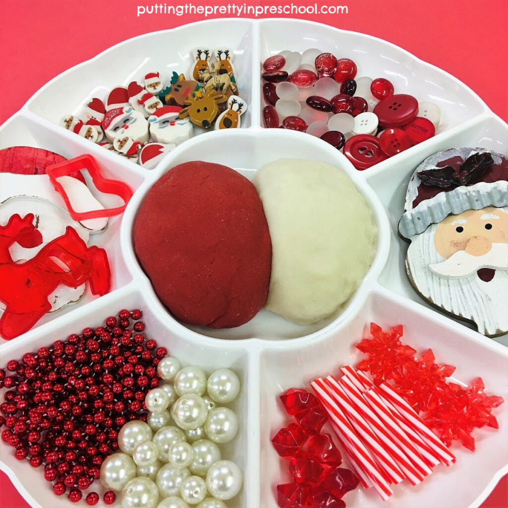 Festive red and white playdough tray with a Santa Claus and reindeer theme.