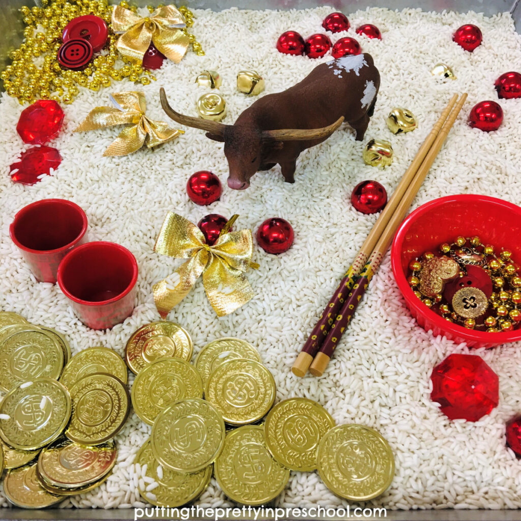 Year of the Ox Chinese New Year rice tray featuring a bull figurine and red and gold loose parts.