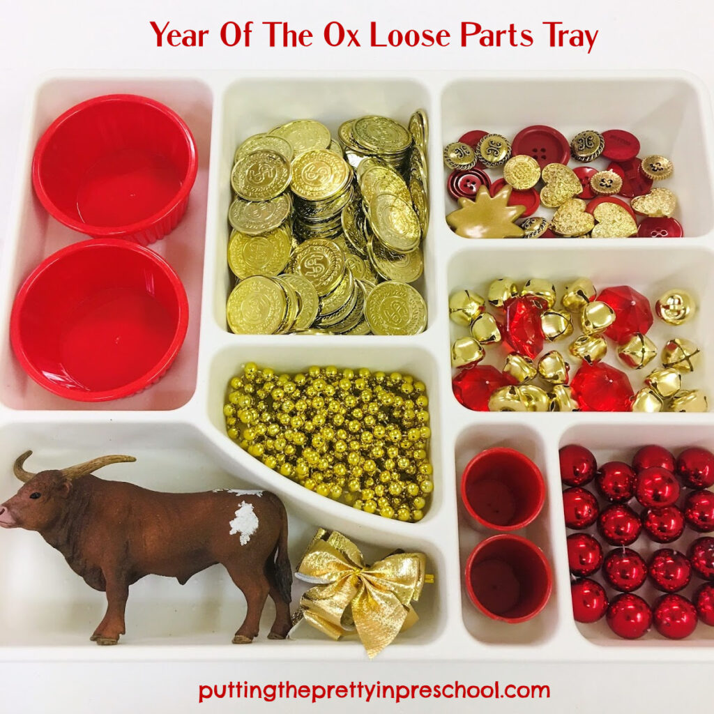 Year of the Ox tray featuring a bull figurine and red and gold loose parts.