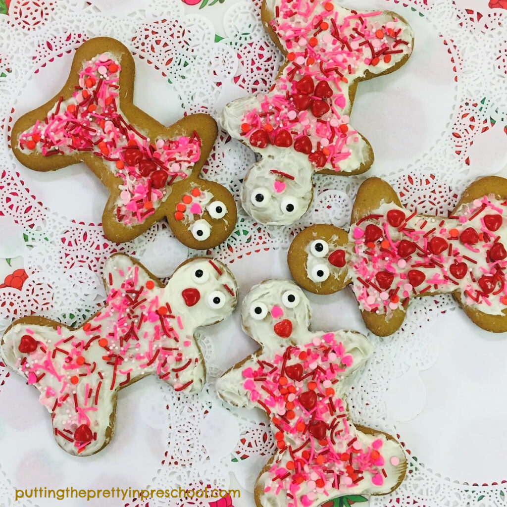 Gingerbread cookies decorated with hearts and candy sprinkles.