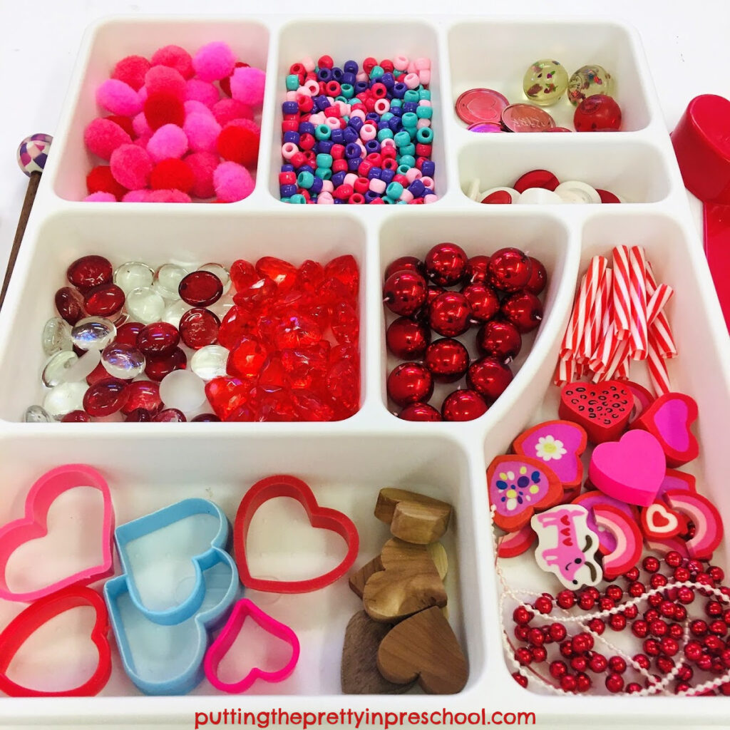 Loose parts to add to Valentine's Day containers to make shaker and drum musical instruments.