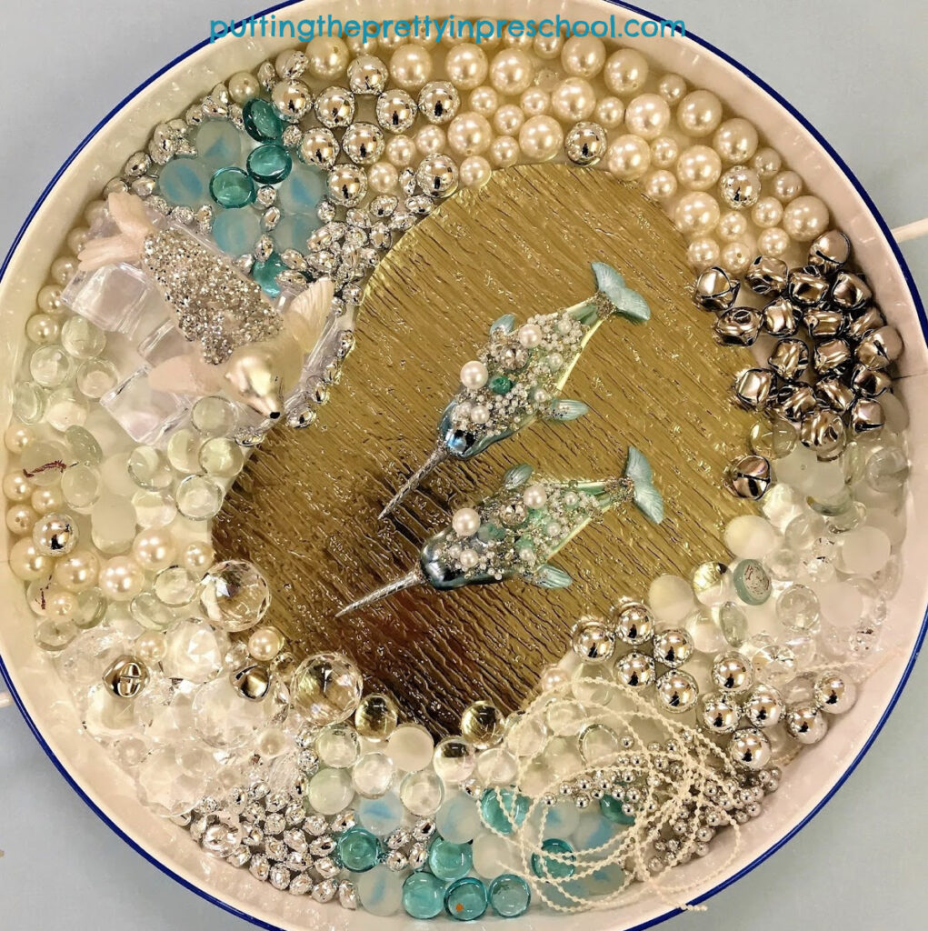 A glittery seal and embellished narwhals are the highlights of this luxurious sensory tray.