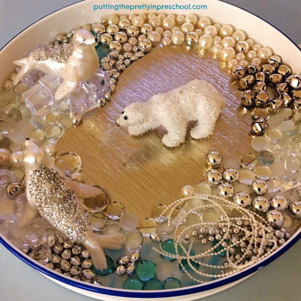 Polar bear and seal sensory tray with luxurious loose parts.