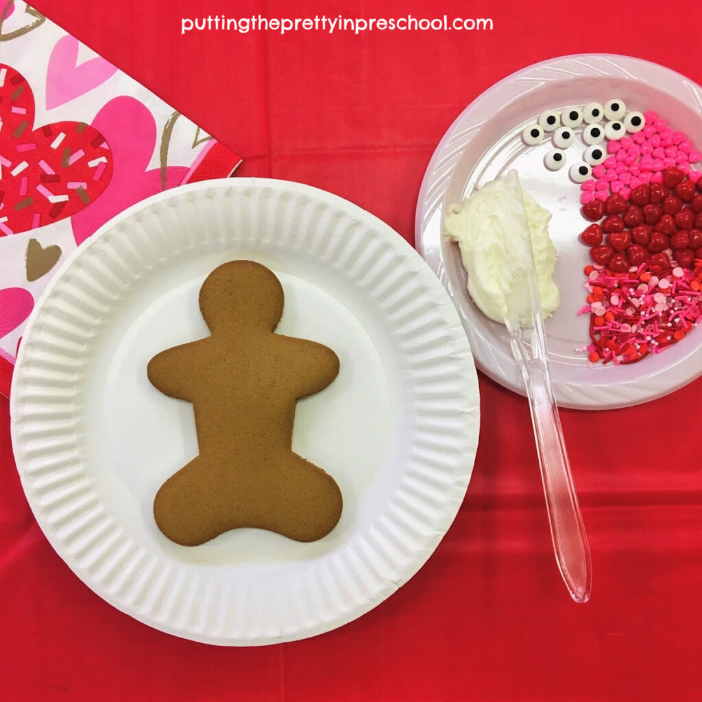 Gingerbread cookie decorating station with Valentine's Day-themed decorations.