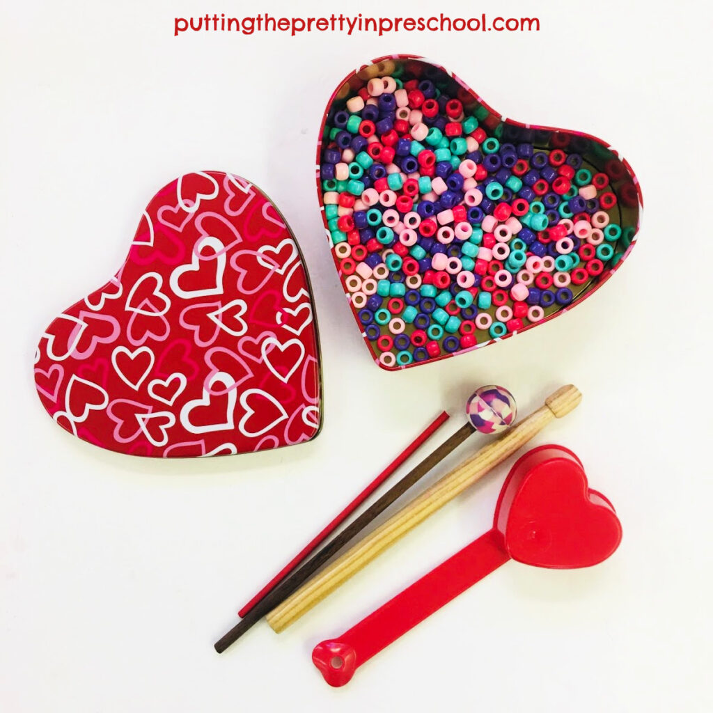A heart-shaped tin with pony beads added makes an ocean drum.