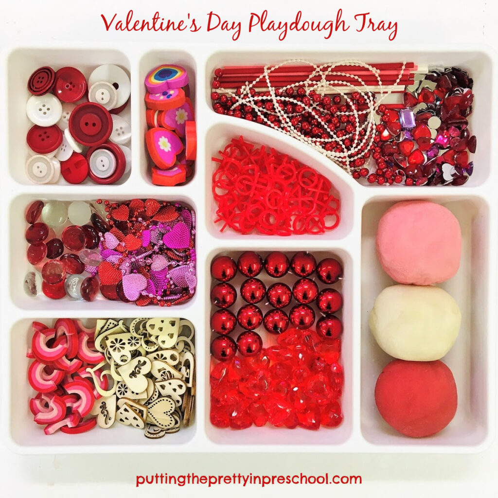 Valentine's Day playdough tray with loose parts and red, pink and white dough recipes.