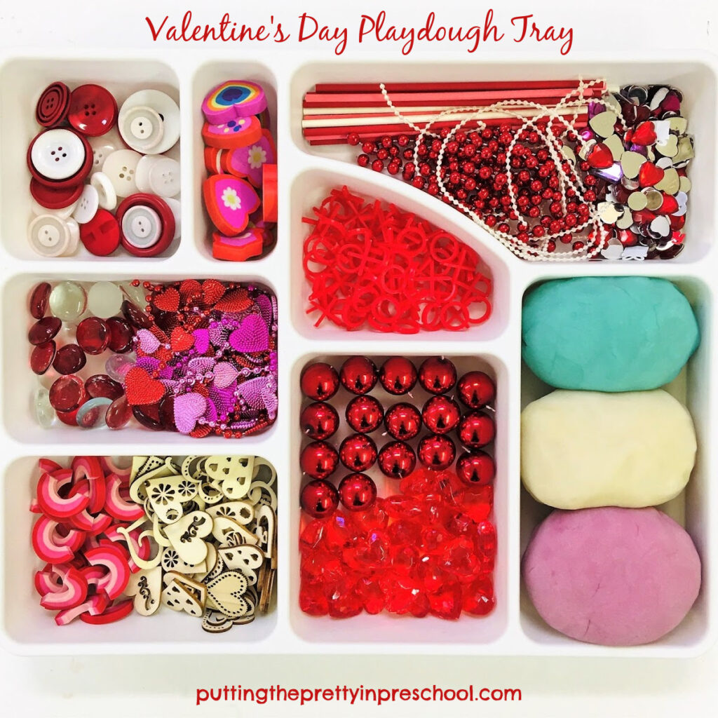 Valentine's Day playdough tray with loose parts and blueberry, white, and lilac dough recipes.