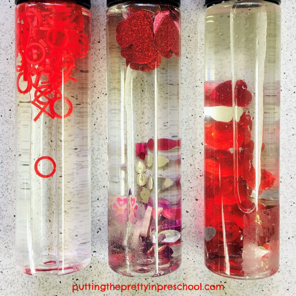 Sensory tubes with Valentine's Day themed loose parts.