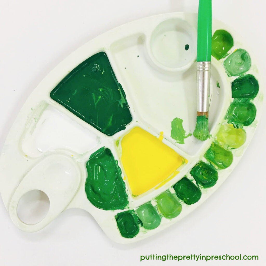 Color mixing painting exercise with green, yellow, and white paint.