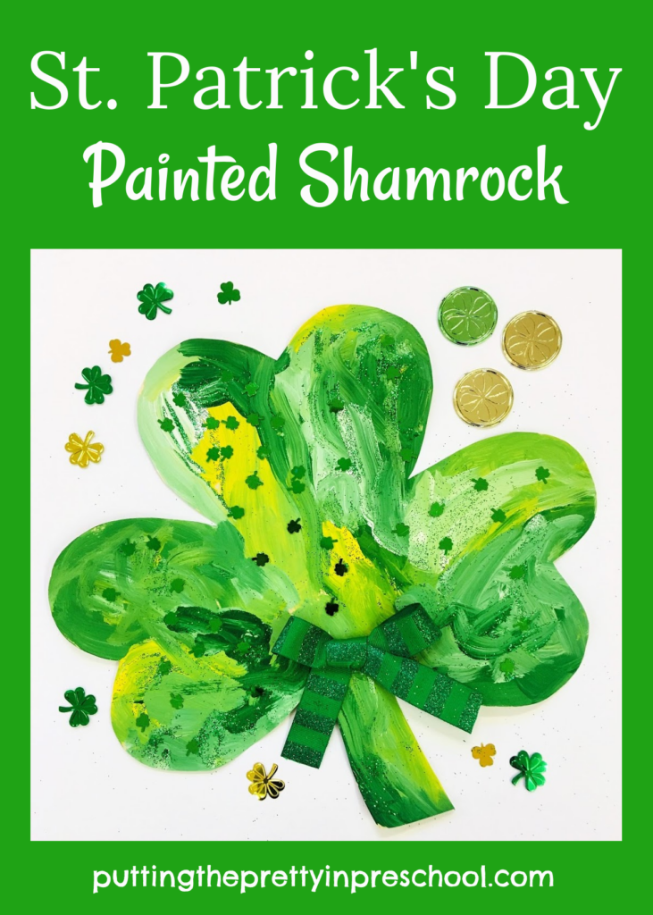 A painted shamrock sprinkled with green glitter and shamrock confetti. An all-ages art activity.