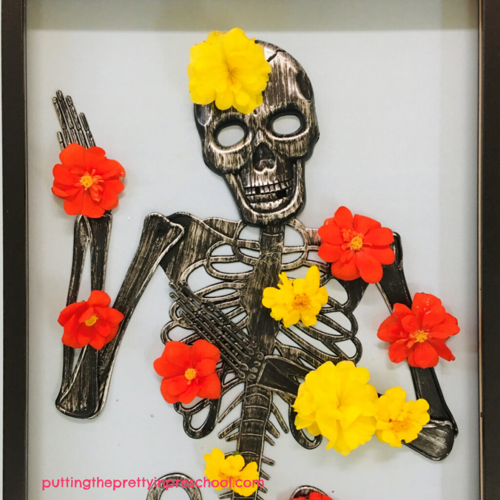 Yellow and orange flowers brighten up this skeleton and allow children to become floral designers.