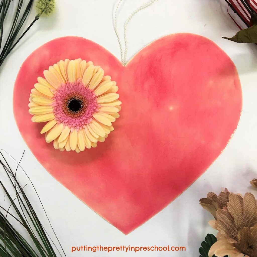 A pretty flower and heart craft showcasing a gerbera daisy flower.